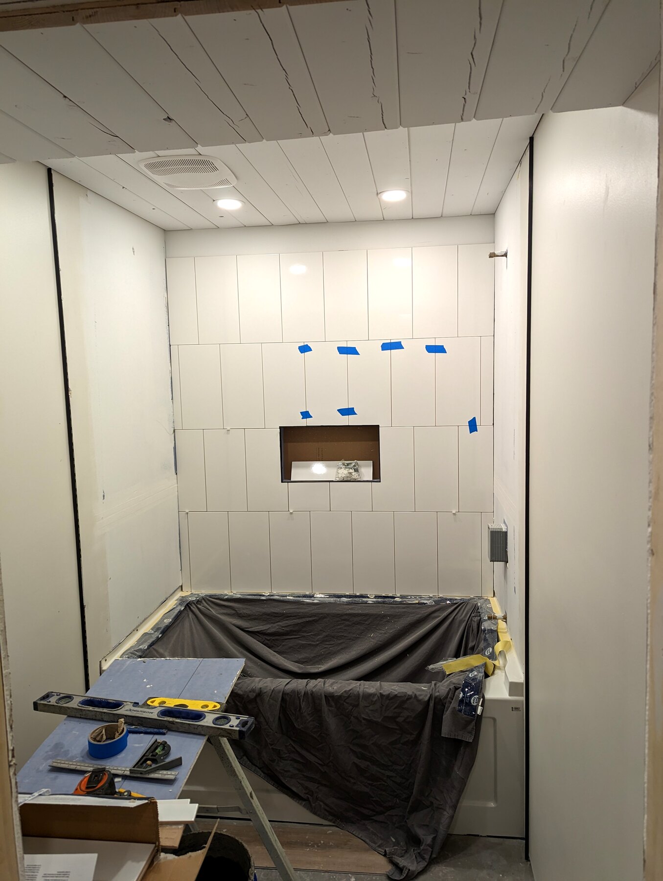 Basement bathroom with wall board and floor protection in place