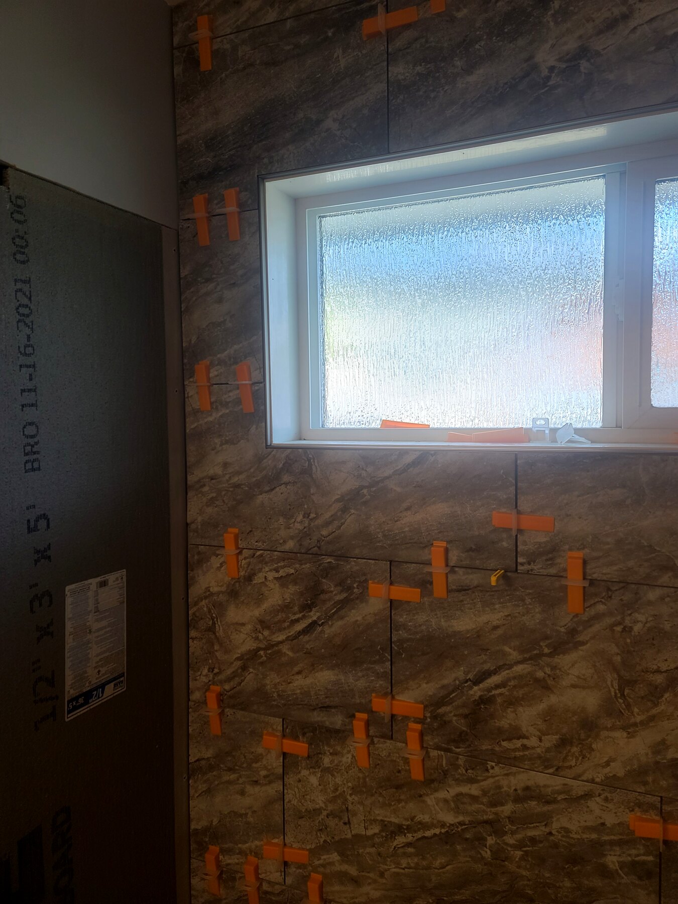 Close view of bathroom wall waterproofing around a window