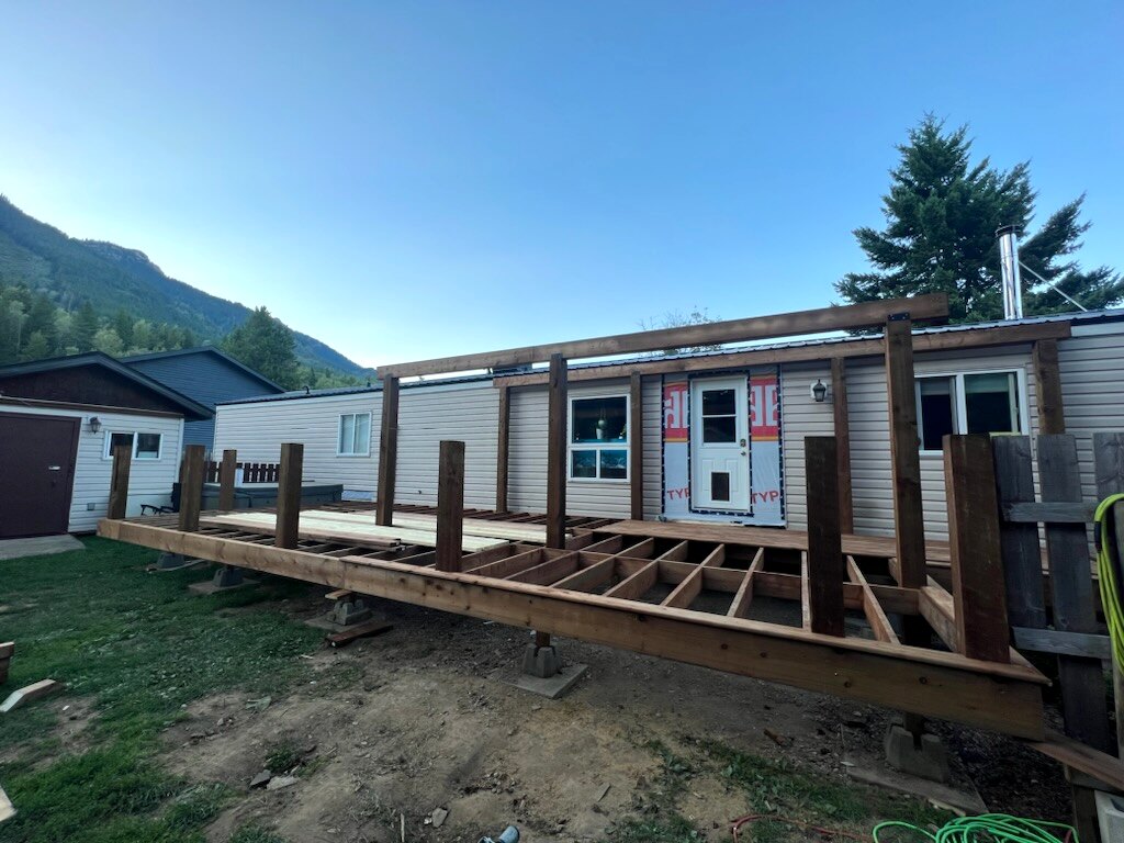Deck framing and posts beside a manufactured home