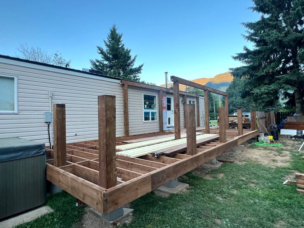 Deck framing with upright posts and an unfinished railing structure