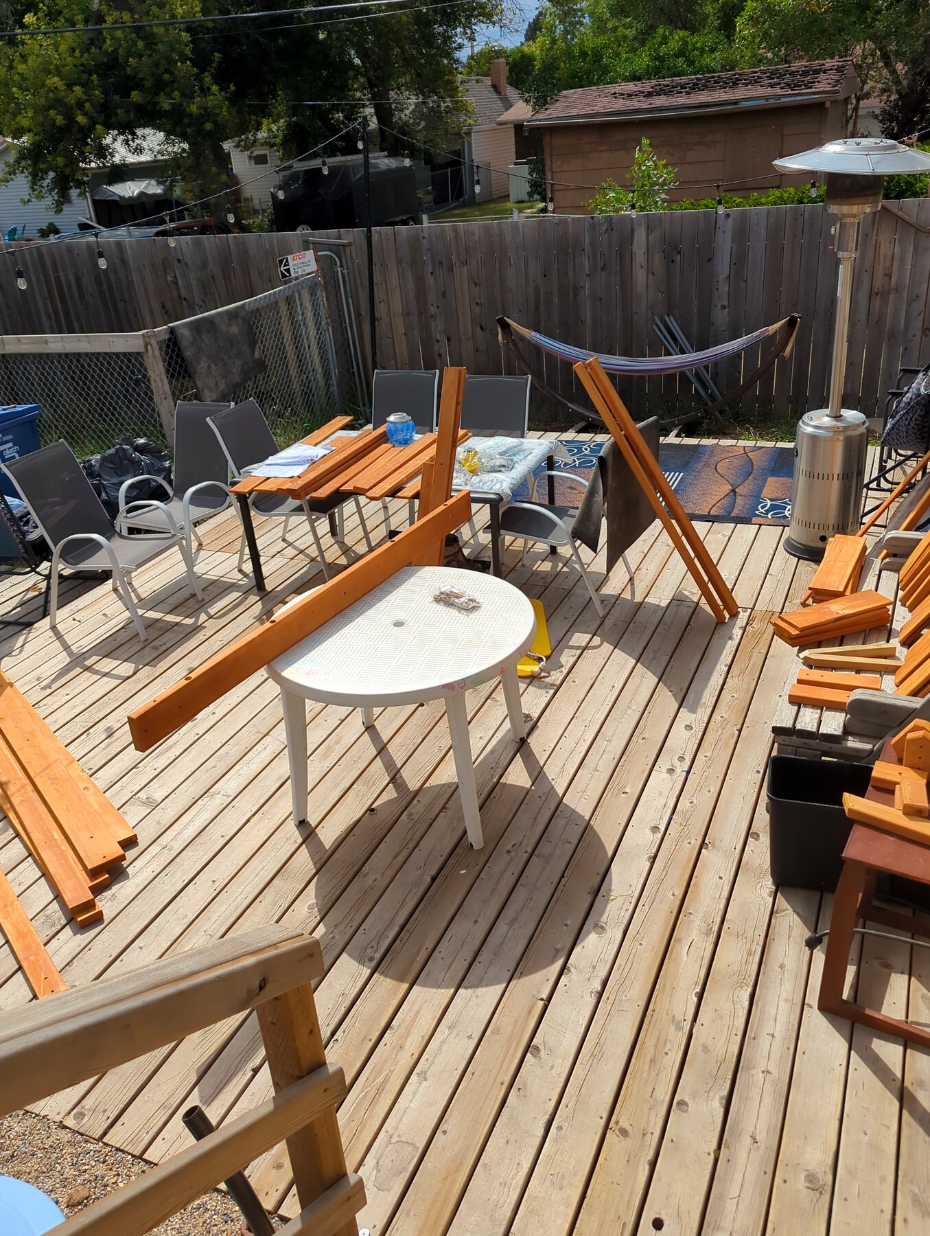 Completed wood deck with outdoor seating and privacy fencing