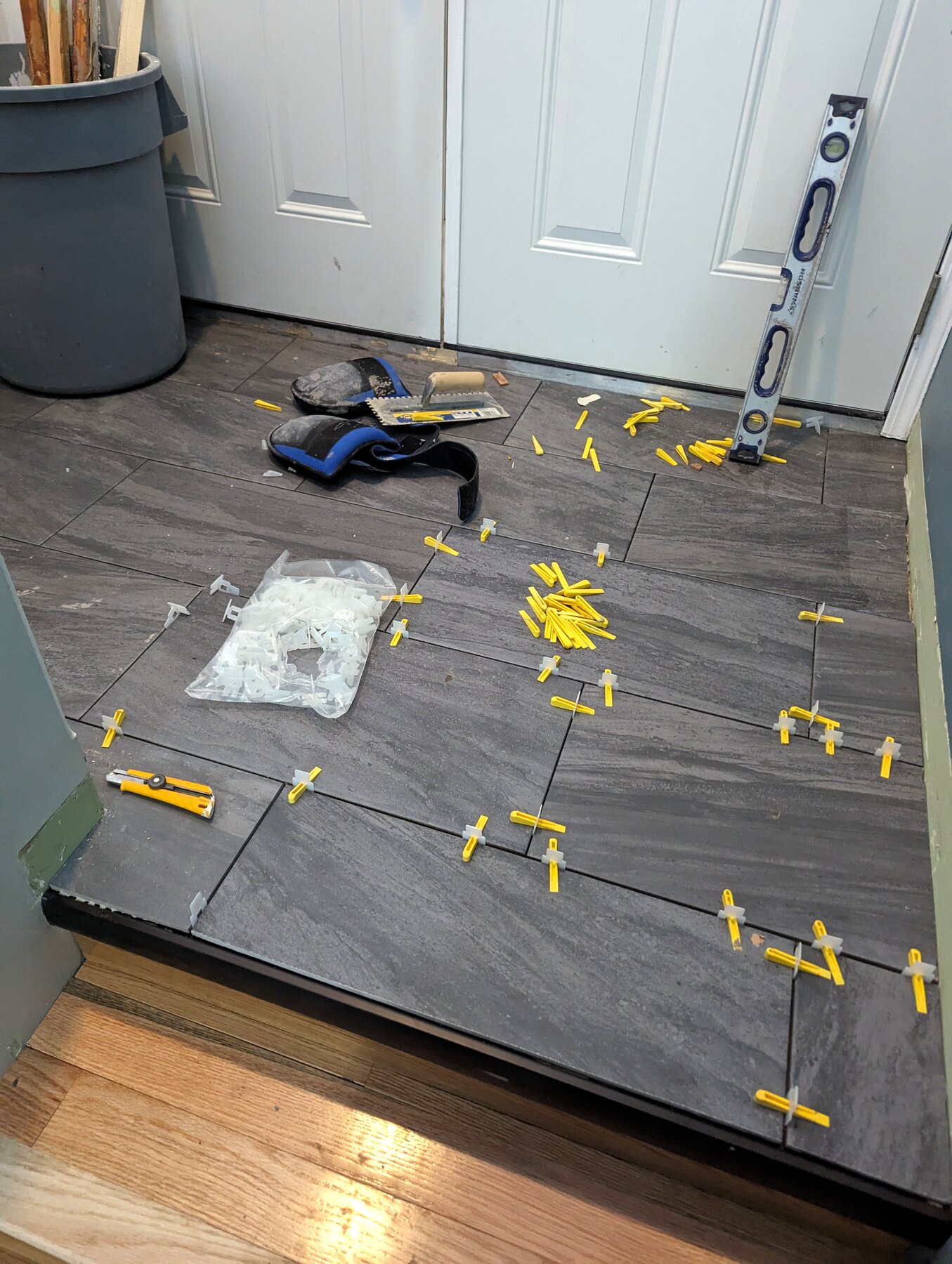 Large floor tiles being installed with levelling clips