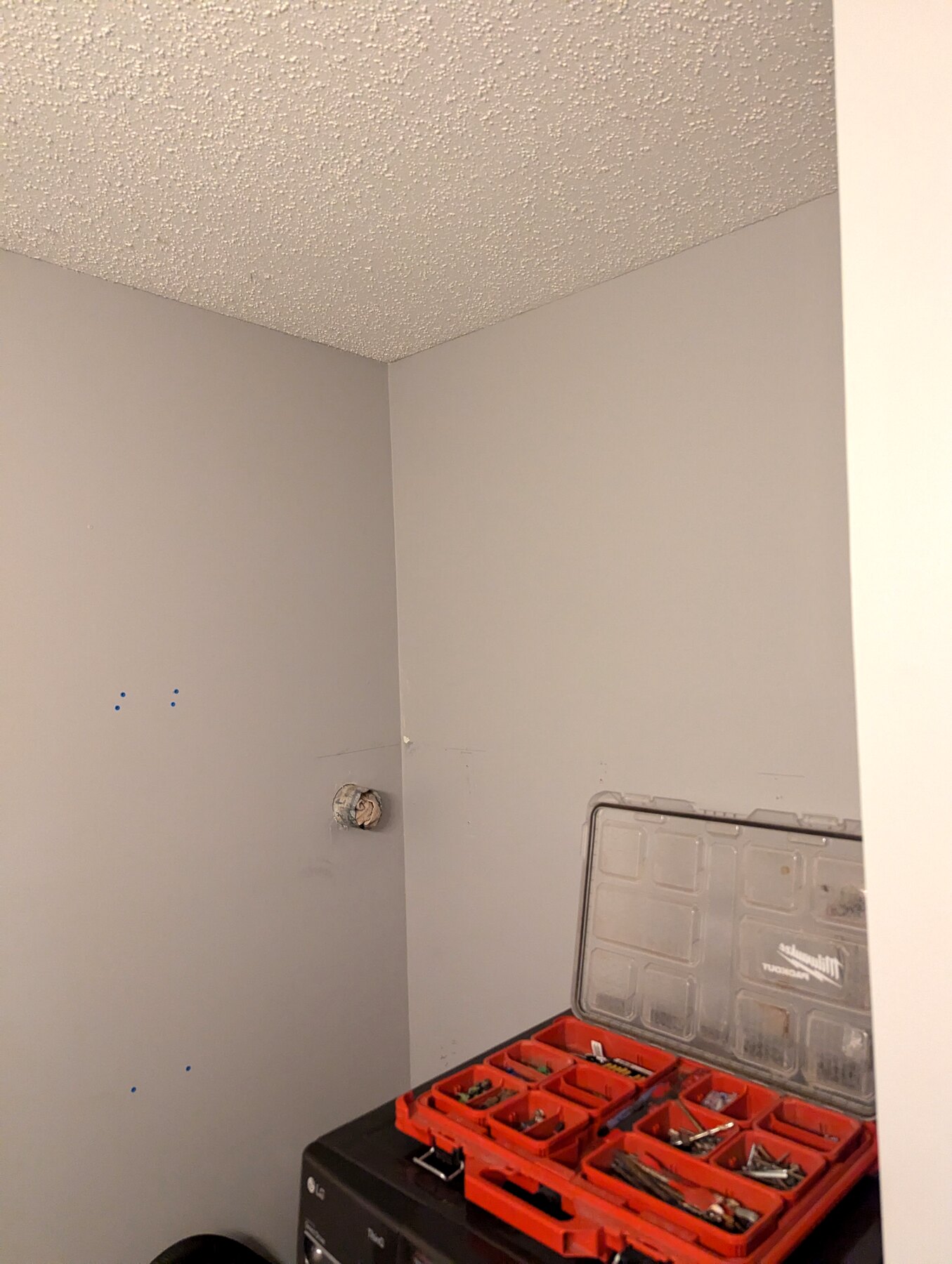 Painted interior room with finished flooring and a tool case on site