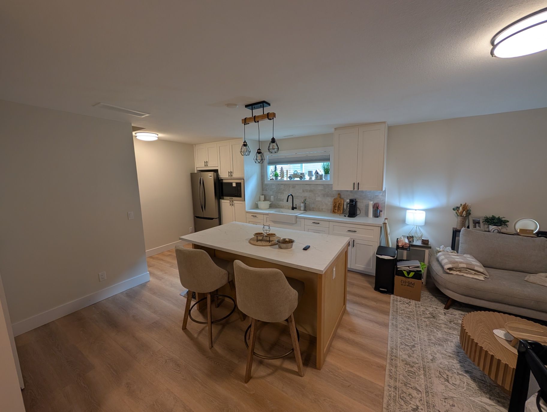 Wide view of the kitchen island, cabinetry, and seating area