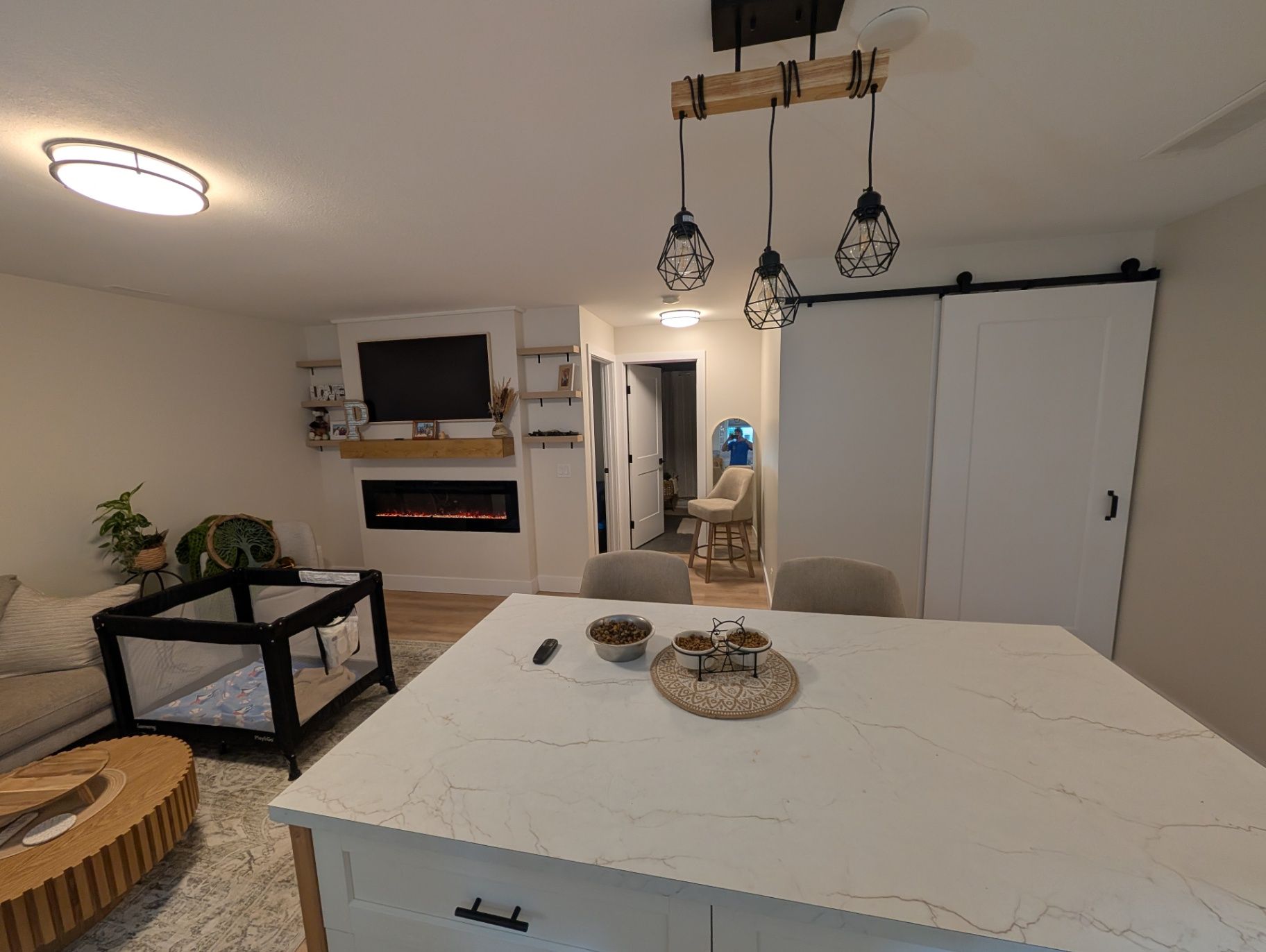 View across the kitchen island toward the fireplace and living area