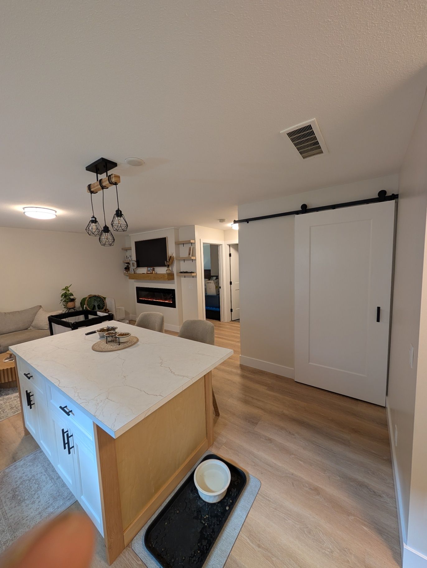 View across the kitchen island toward the living area
