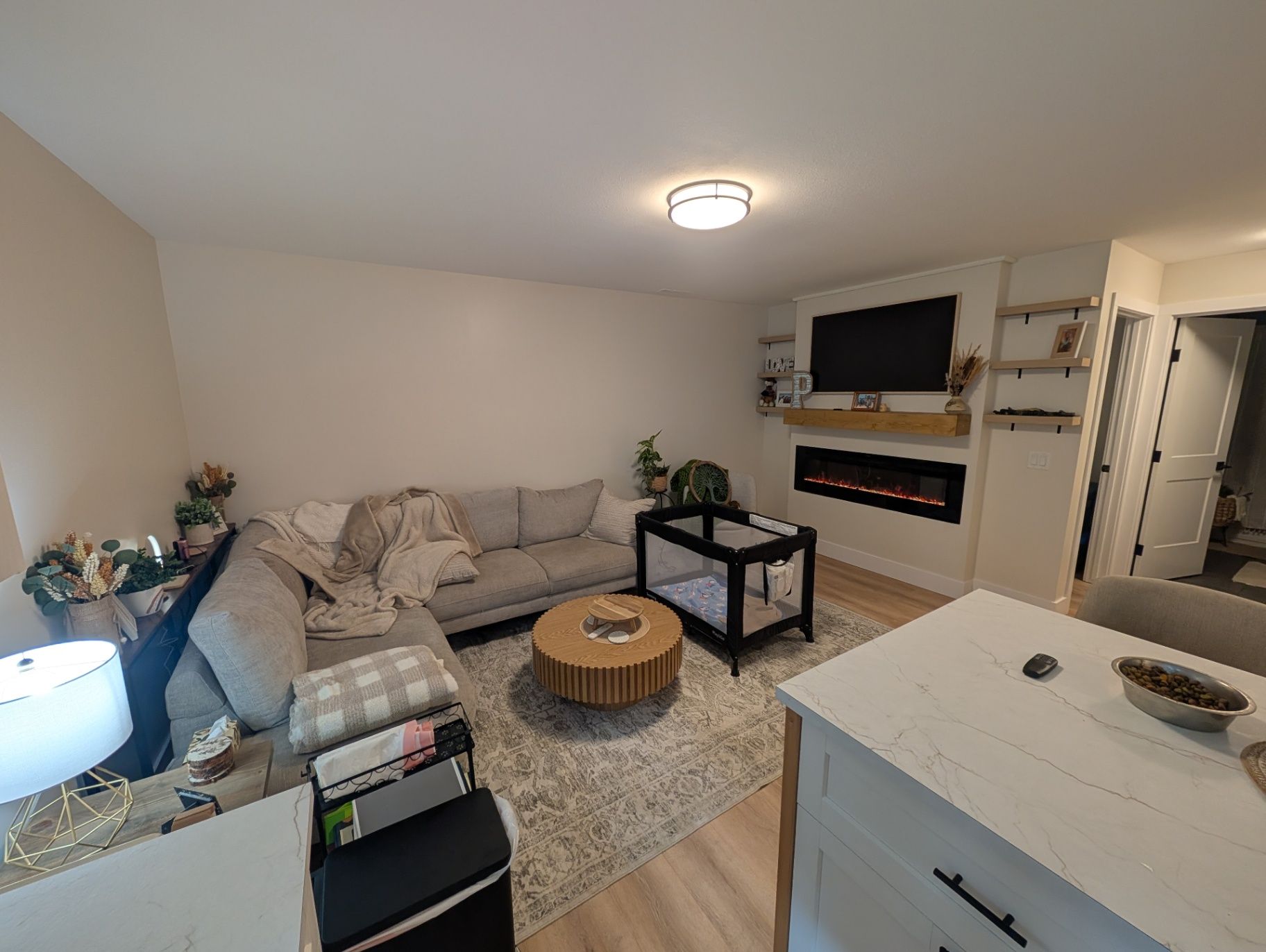 Wide view across the living area toward the fireplace