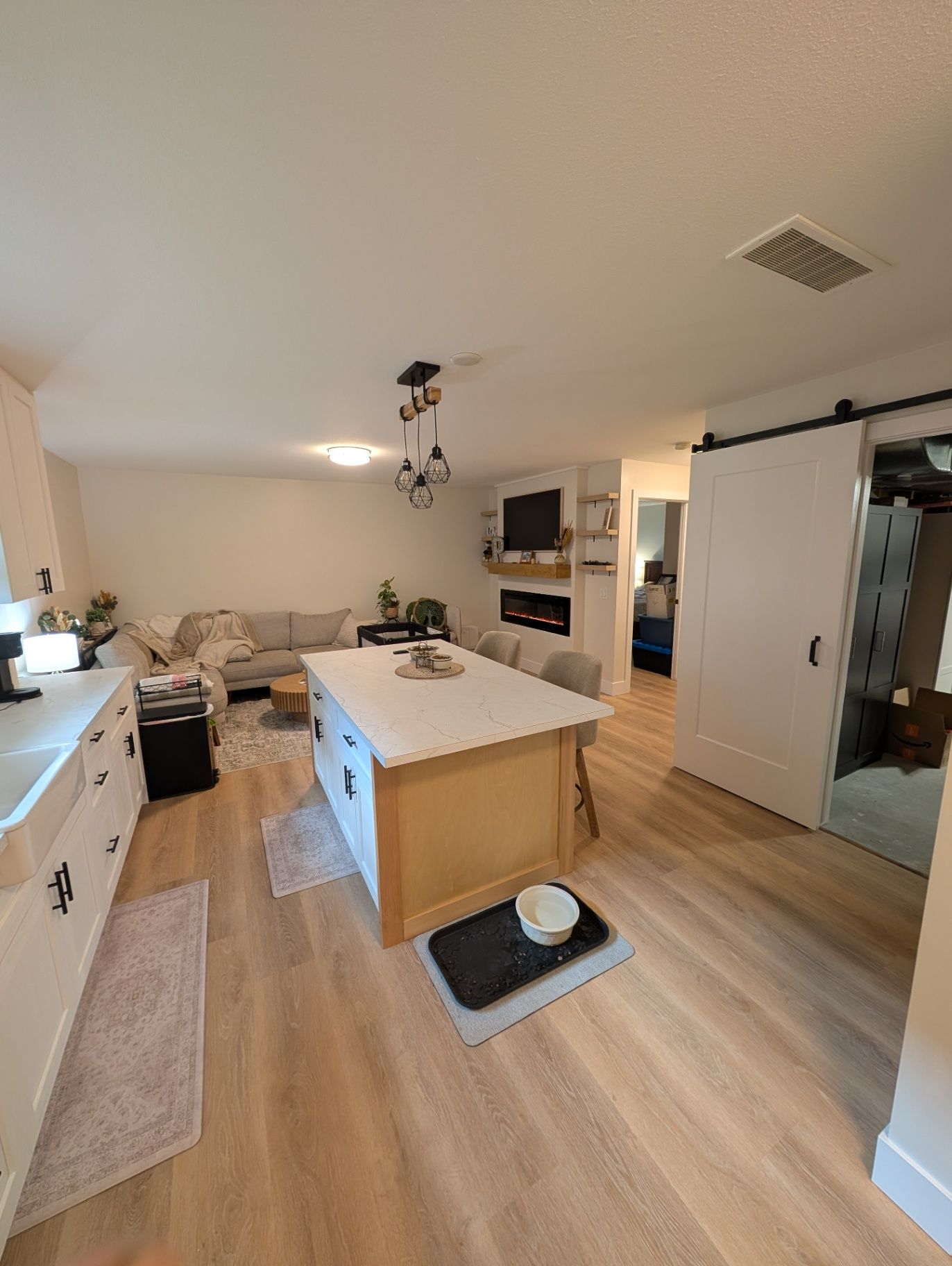 View from the kitchen toward the living area and storage door