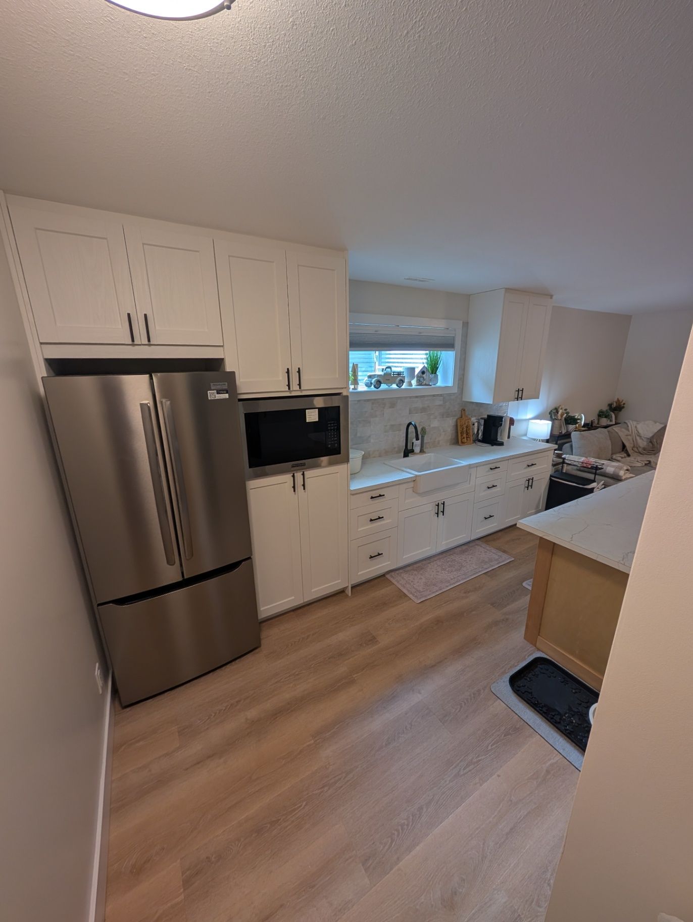 View of the kitchen cabinetry, appliances, and work surface
