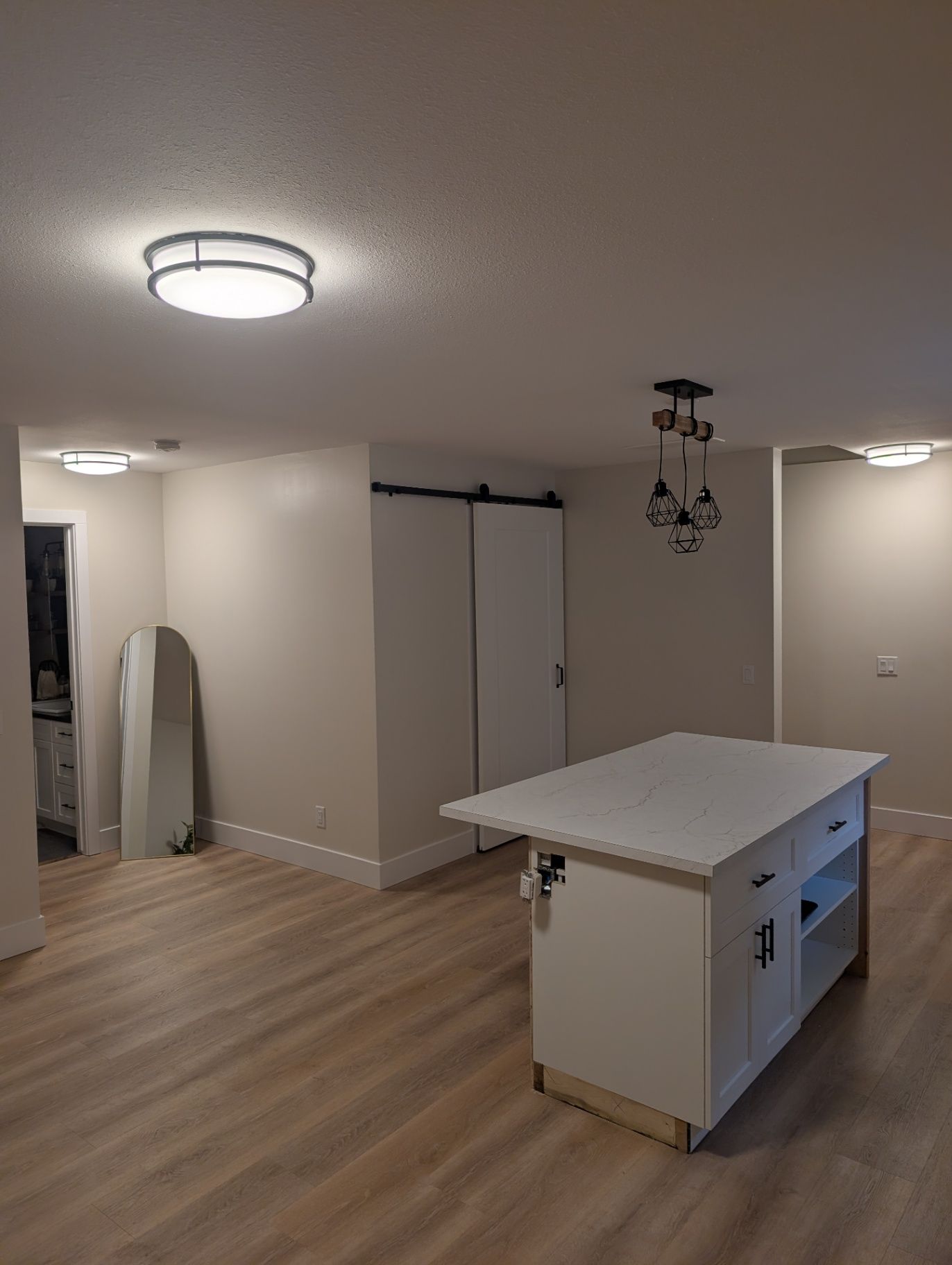 View of the kitchen island and adjacent room