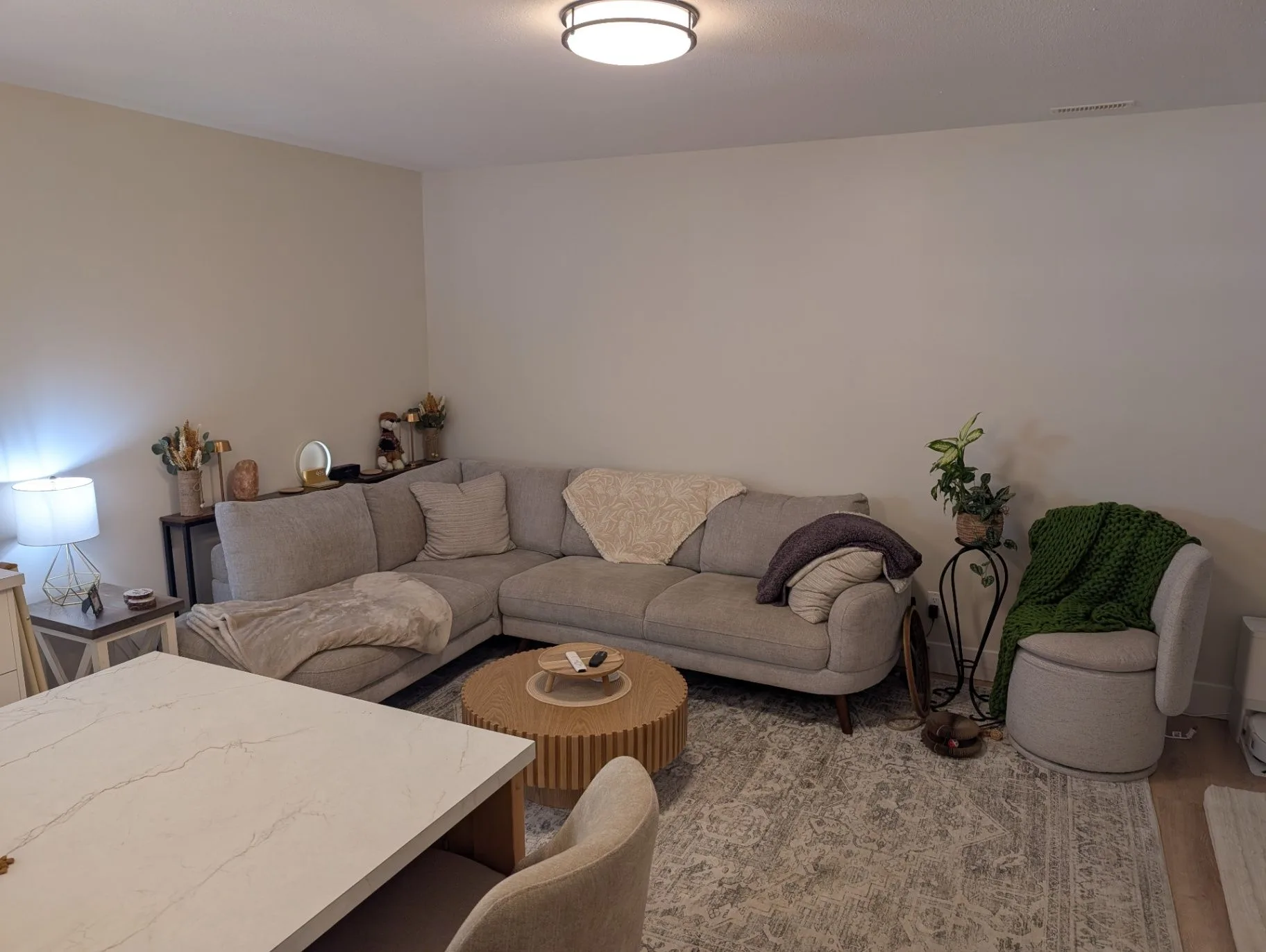 Basement renovation in Elkford — finished living room with sectional seating