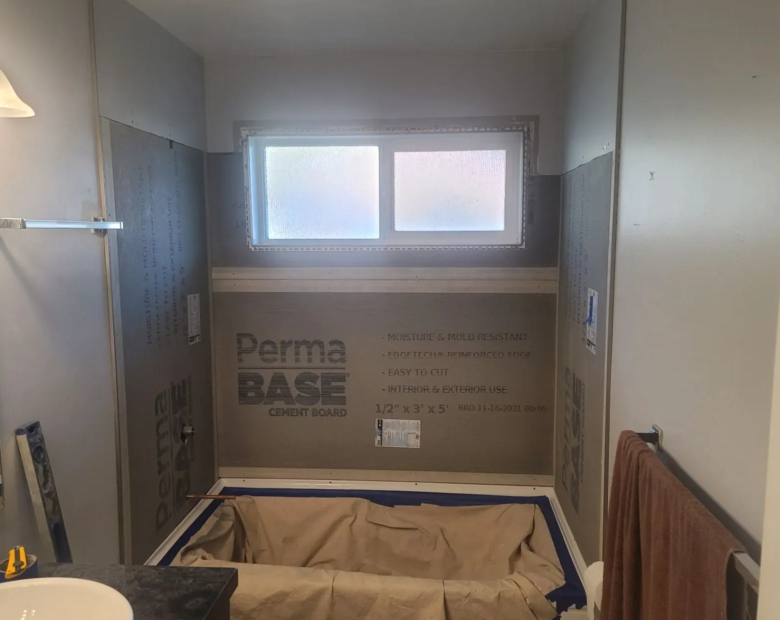 Bathroom tub surround with cement backer board and floor protection in place