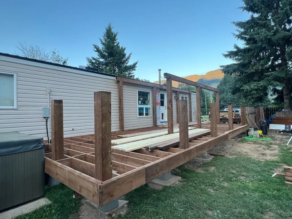 Deck extension framing beside a residential building