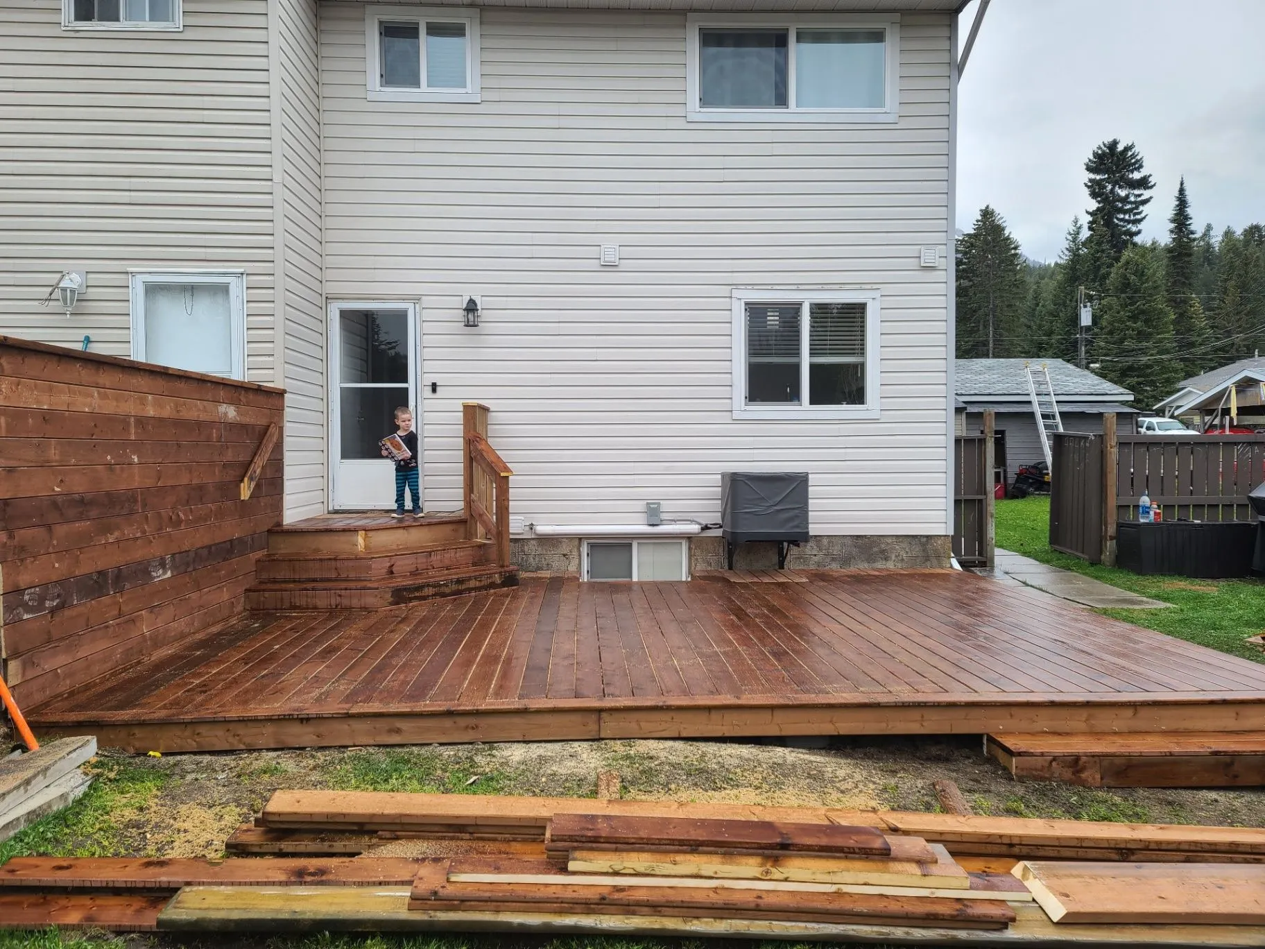 Residential deck with railing work and loose boards on site