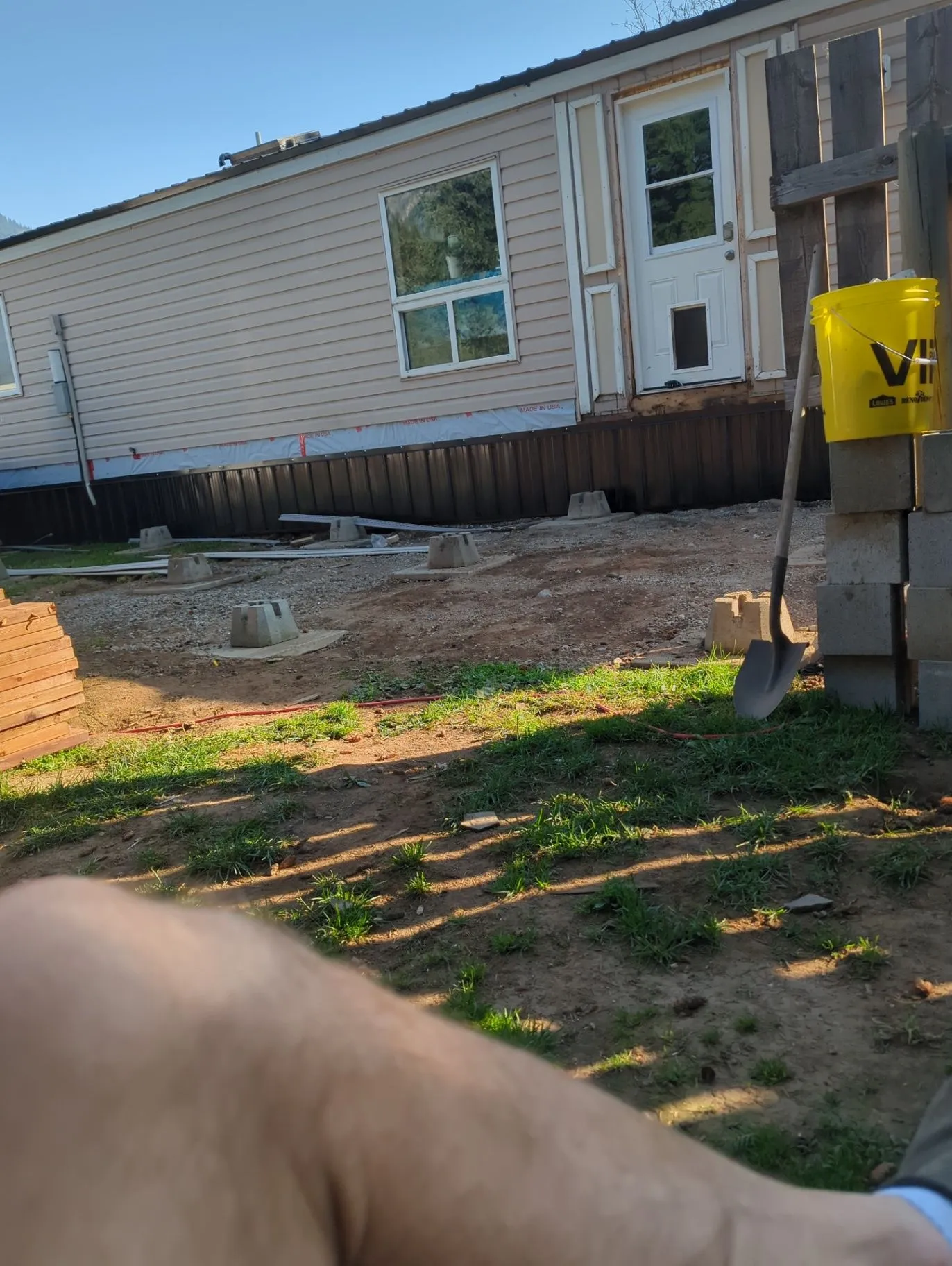 Side exterior work underway beside a residential building