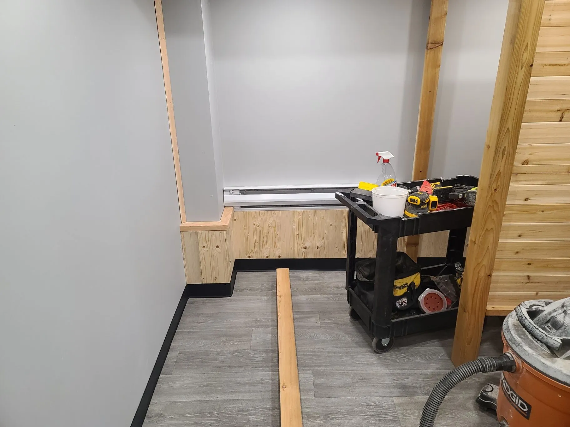 New flooring and trim work in a small interior room