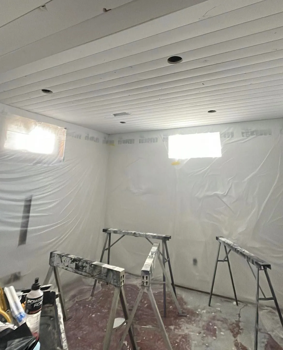 Interior room protected for painting with work stands in place
