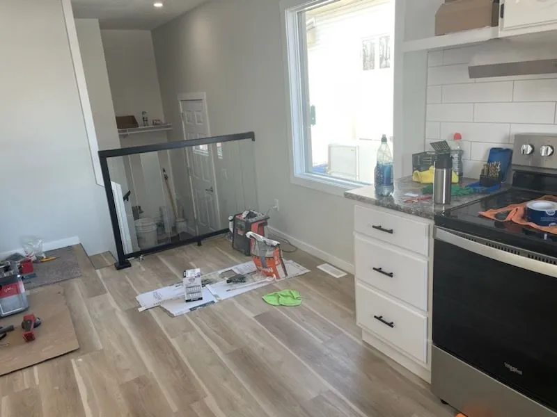Kitchen floor and cabinet installation with tools on site