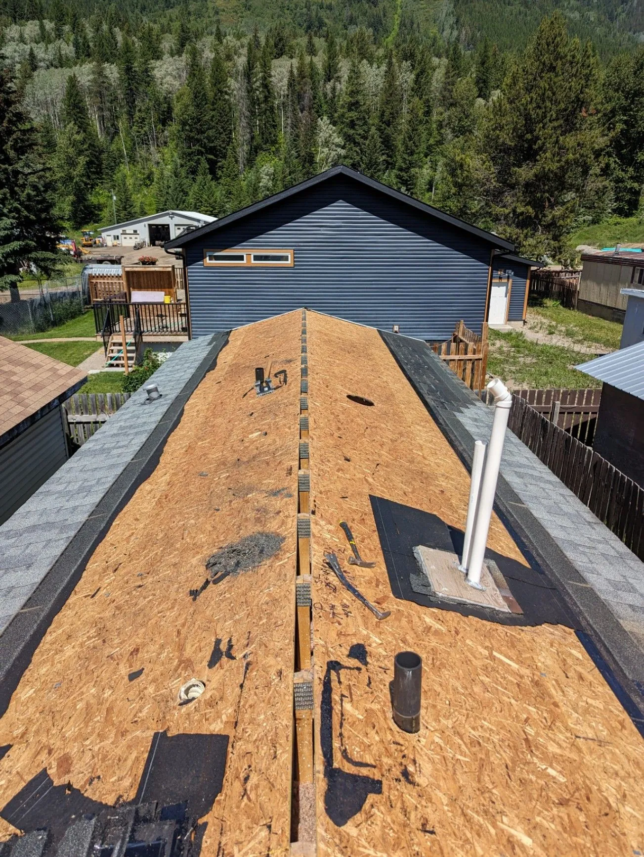 Roof with new OSB sheathing and roof penetrations in progress