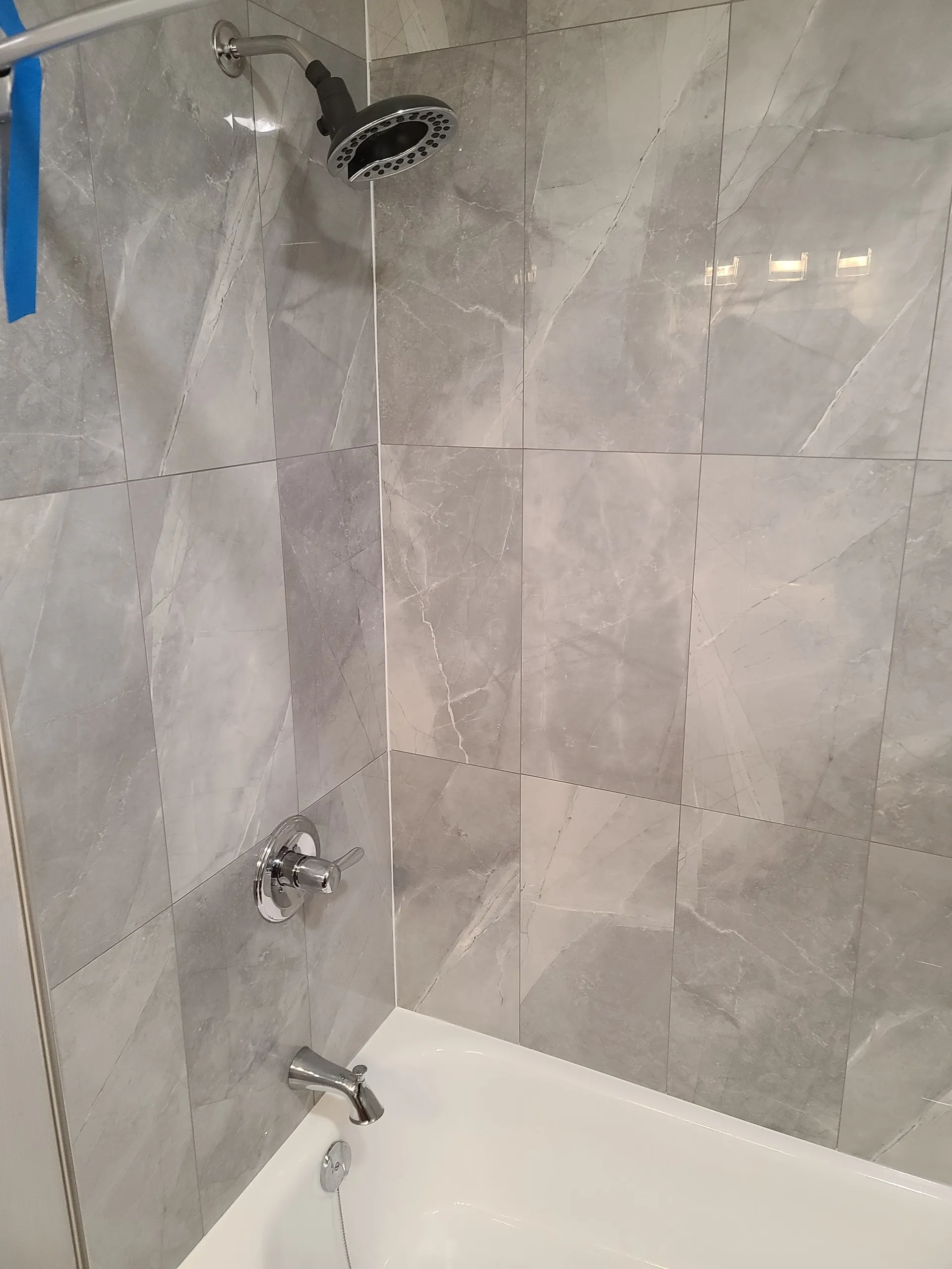 Finished grey tile shower and tub surround