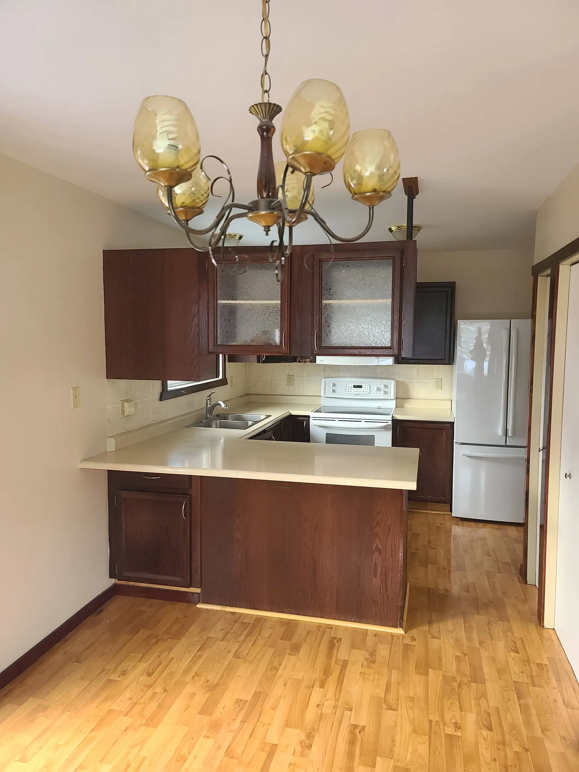 Existing older kitchen with dark wood cabinets