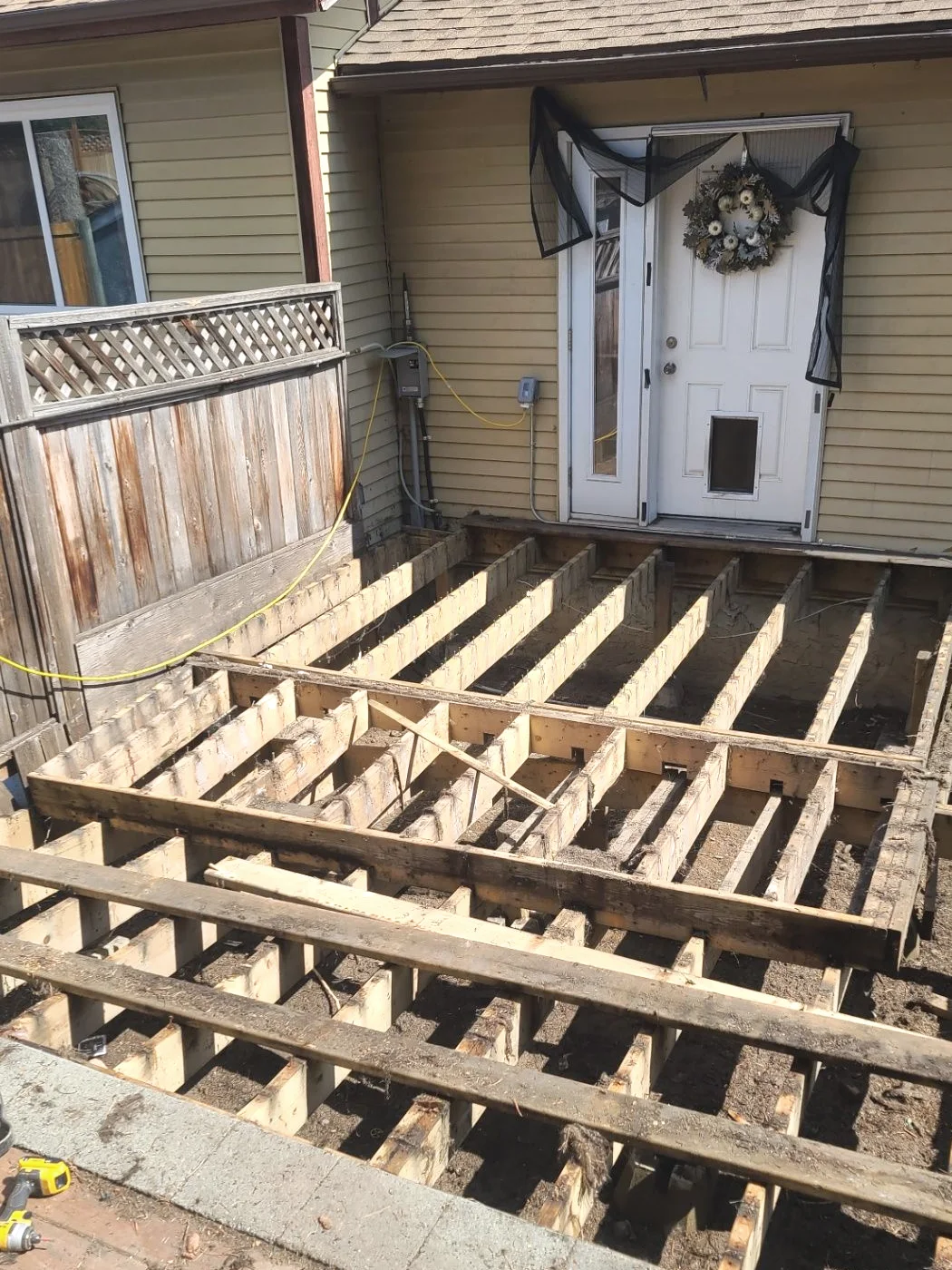 Deck rebuild in progress with new framing laid over the existing structure